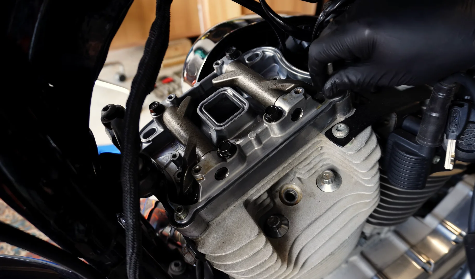 Rocker-box assembly with the upper cover removed, showing the rocker arms and surrounding joint surface.